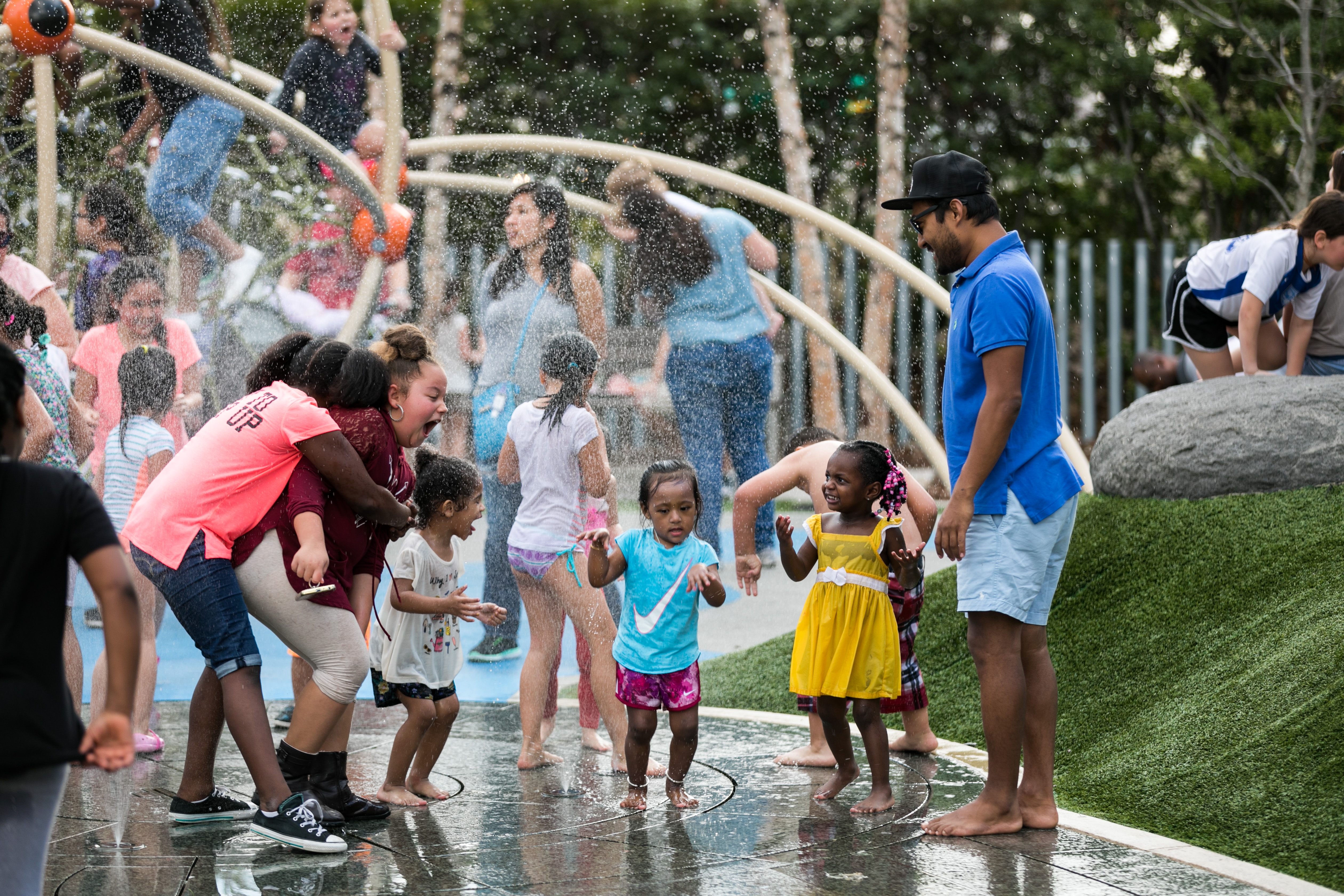 Children playing in a splash park in Klyde Warren Park.